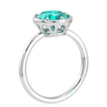 Pel & Co oval Paraiba tourmaline solitaire ring in white gold bezel setting with tapered band – vivid neon blue Paraiba tourmaline