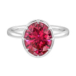 Oval ruby solitaire bezel ring in 14K white gold with tapered band by Pel & Co – luxury ruby engagement ring