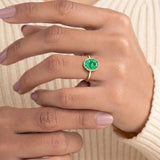 Vivid green oval Colombian emerald solitaire bezel ring with tapered yellow gold band – Pel & Co fine jewelry