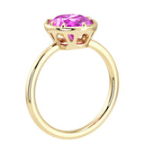 Luxury pink sapphire engagement ring featuring oval pink sapphire center stone and modern bezel setting by Pel & Co