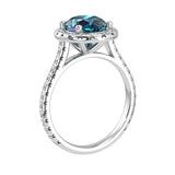 Alexandrite oval ring on hand with diamond band, unique color changing engagement ring