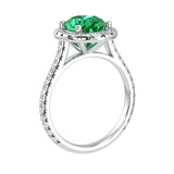 Colombian emerald oval ring on hand with diamond band, luxury lab grown emerald ring