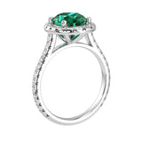 Emerald oval lab created gemstone ring on hand, modern engagement ring with pavé diamonds