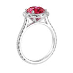 Ruby oval ring on hand with diamond band, bold red gemstone luxury ring