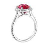 Ruby oval ring on hand with diamond band, bold red gemstone luxury ring