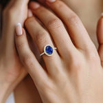 Close up oval blue sapphire ring with french pavé setting, fine jewelry handcrafted 14k gold