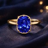 Elongated cushion cut blue sapphire solitaire bezel ring in gold with tapered band by Pel & Co – antique style sapphire engagement ring