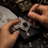 High jewelry jeweler hand-setting luxury diamonds and rare gemstones on an intricate custom fine jewelry piece by Pel & Co. Expert craftsmanship featuring bespoke jewelry design, diamond setting, gemstone sourcing, and handcrafted high jewelry made in Los Angeles, USA.