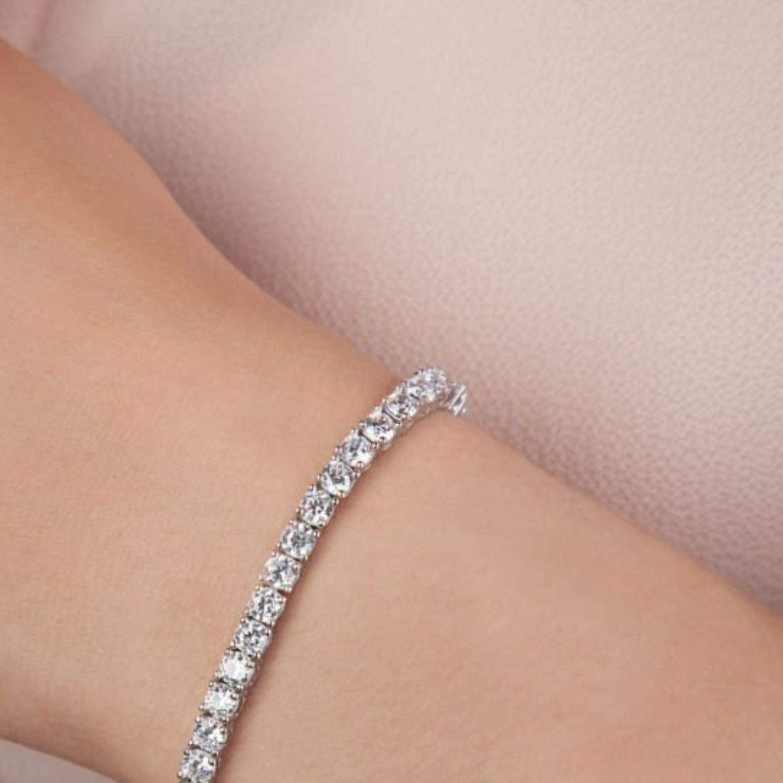 Diamond bracelet on a person's wrist with a soft background